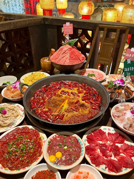 A table set with hot pot ingredients and sauces in a Chengdu restaurant