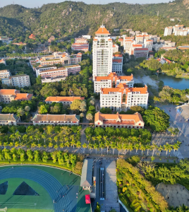 Aerial view of Xiamen University campus with sea and mountains
