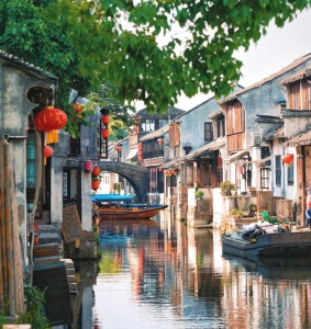 Zhouzhuang Water Town canal scene with boats and red lanterns