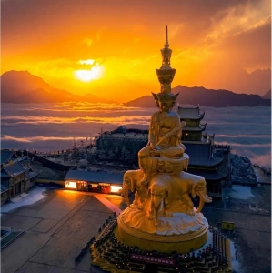 Sunrise over the golden Buddha at Mount Emei Golden Summit