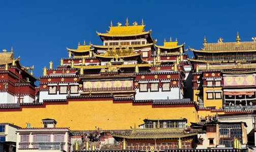 Songzanlin Monastery exterior golden roofs under blue sky