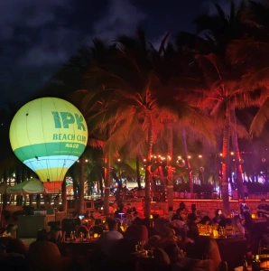 IPK beach club at night with colorful lighting and crowd