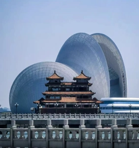Tourists taking photos at Zhuhai Opera House with traditional pavilion in view