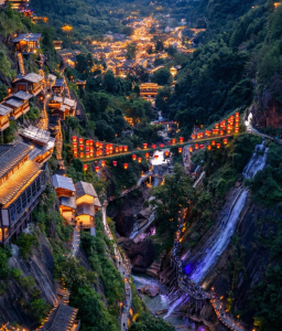 Night view of Vagoo (Wangxian Valley) canyon with lantern bridge