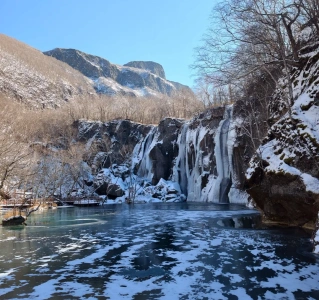 Green Deep Pool surrounded by winter landscape in Changbai Mountain