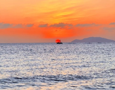 Beautiful ocean sunset view with fishing boat