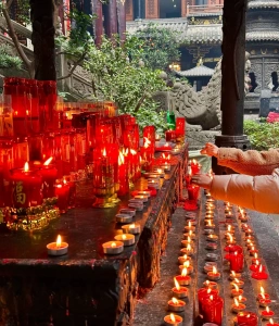 Visitors lighting candles and praying for blessings at Luohan Temple