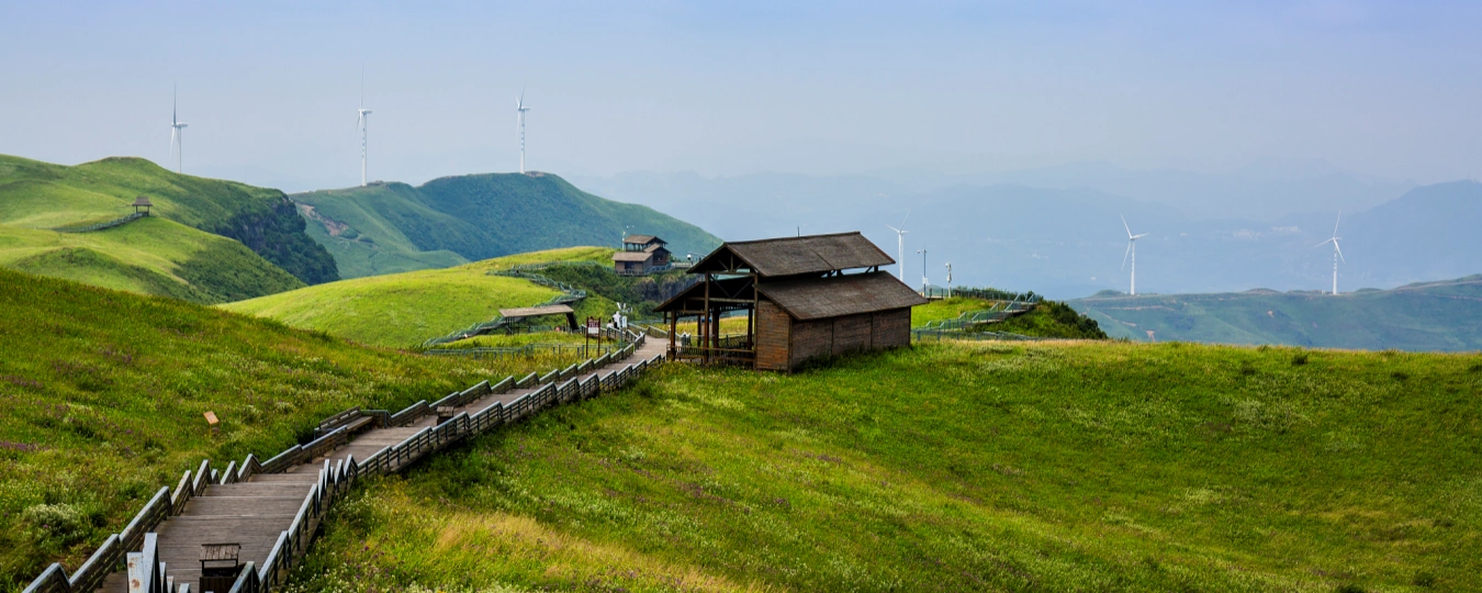 Scenic grassland and wooden cabins at Fairy Mountain National Forest Park