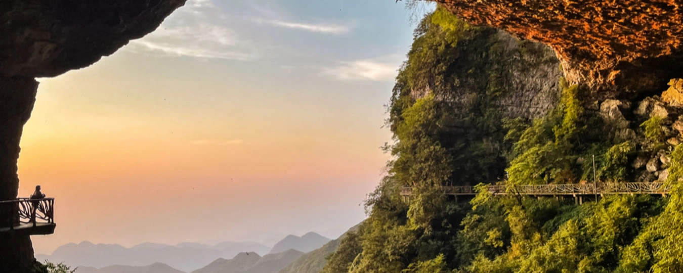 Cliffside walkway at sunset in Gold Buddha Mountain