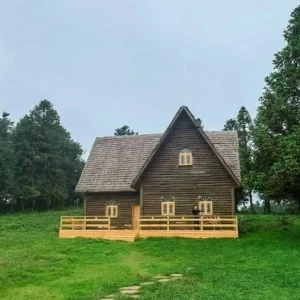 Wooden house surrounded by forest at Fairy Mountain National Forest Park