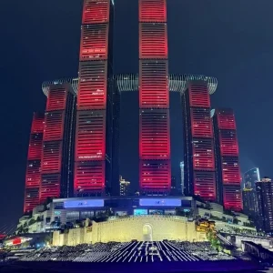Chongqing Raffles City glowing at night during the Two Rivers Night Cruise