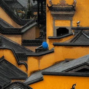 Close-up of ornate yellow walls and tiled roofs at Huguang Guild Hall