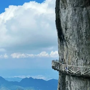 Scenic high-altitude walkway along cliff edge at Gold Buddha Mountain